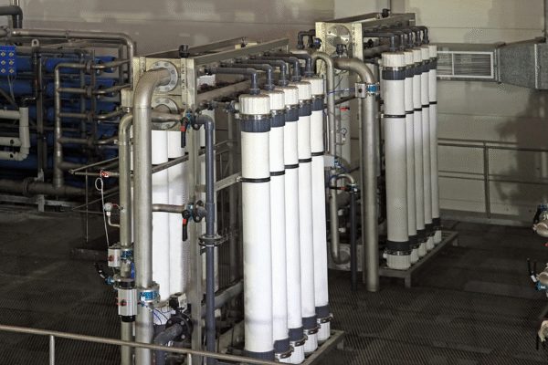 Industrial reverse osmosis system with pretreatment filters and piping, representing the role of RO system coagulants in preventing membrane fouling.