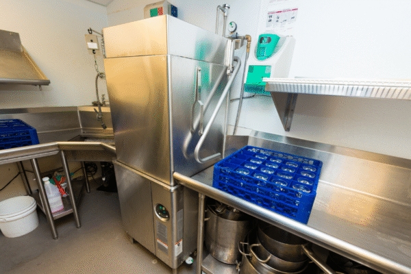 Stainless steel dishwashing unit representing clean in place systems in food and beverage processing