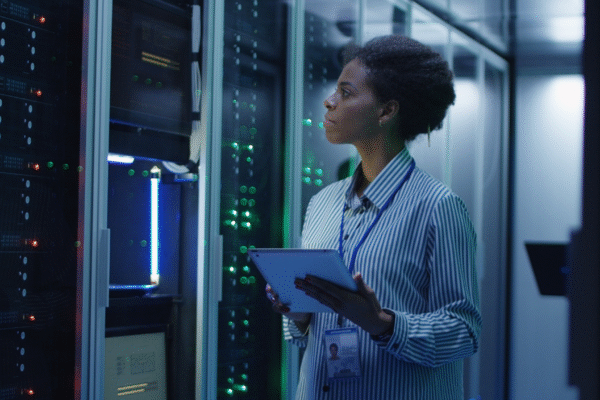 Engineer conducting water-linked system checks in a high-density data center to prevent failure.