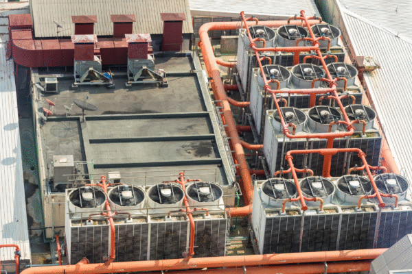 Aerial view of rooftop cooling towers and piping vulnerable to intermittent water supply issues in data center infrastructure.