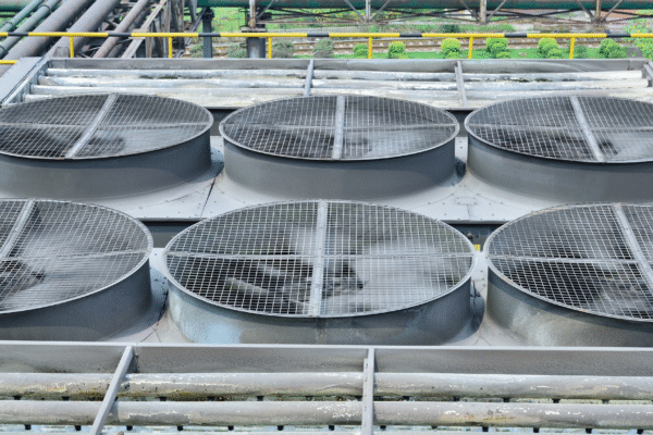 Industrial cooling tower approach measurement example with large rooftop cooling towers and airflow outlets.