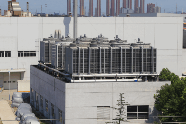 Industrial cooling tower blowdown system with multiple rooftop cooling towers operating to manage heat and water efficiency.